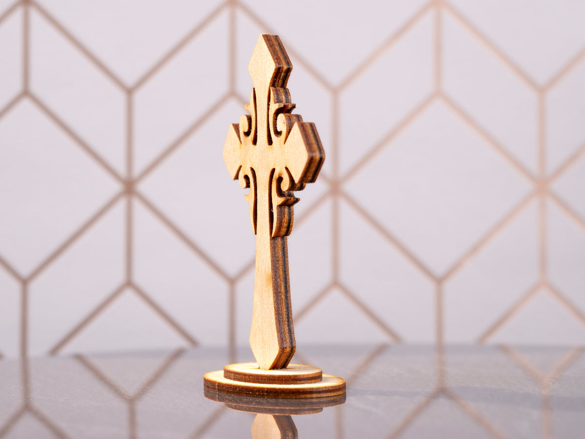 Angled rear view of the standing wooden cross showing the plain wood back, layered edges and oval base.