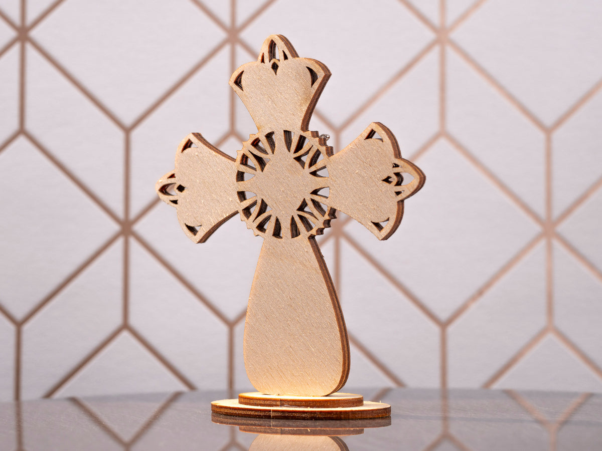 Back view of the standing wooden cross with its round base.