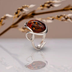 BalticBliss genuine amber adjustable ring with elongated cognac Baltic amber cabochon in elegant sterling silver swirl setting, authentic Lithuanian handmade Baltic amber jewelry, luxury real amber ring gift for women