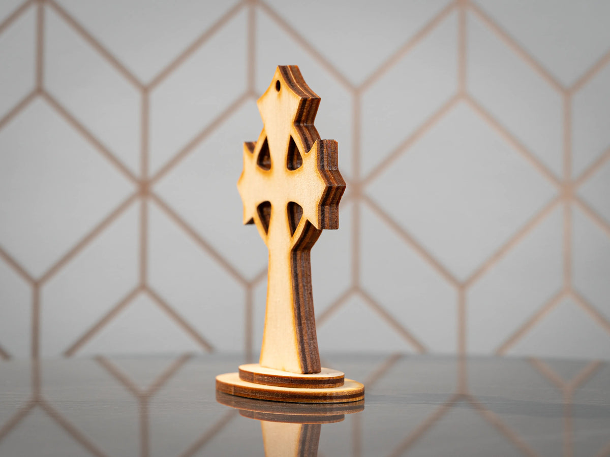 Angled rear view of the standing wooden cross showing the plain wood back, layered edges and oval base.